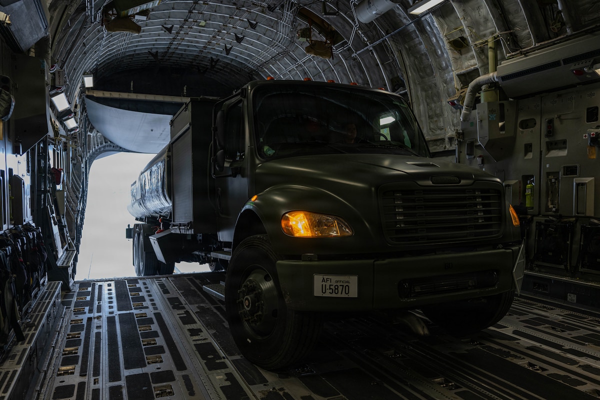 Airmen load a fuel truck.