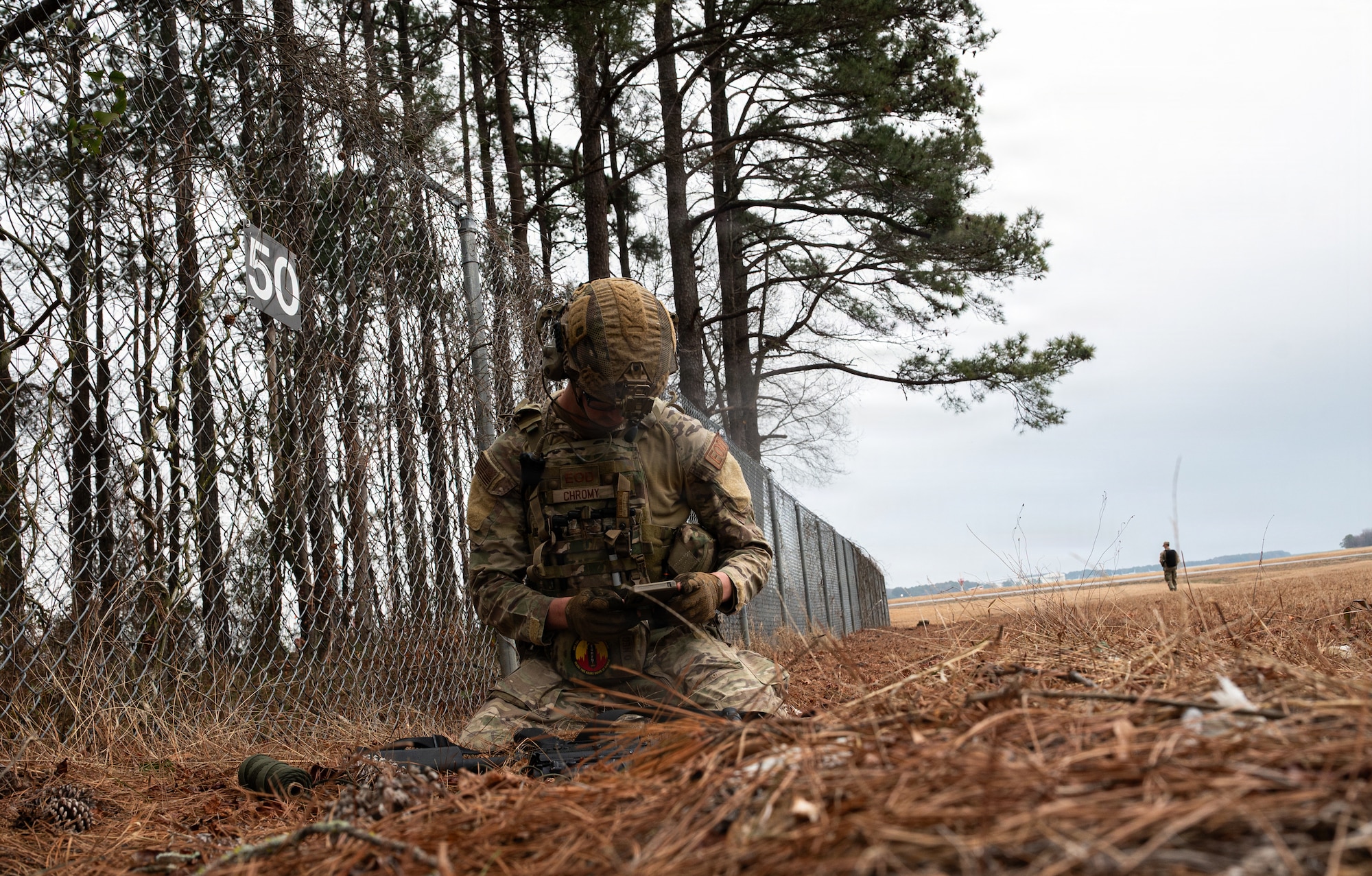 U.S. Air Force Staff Sgt. Ian Chromy, 4th Civil Engineer Squadron, explosive ordnance disposal technician, disables a simulated enemy weapon during a Field Training Exercise at Seymour Johnson Air Force Base, North Carolina, Jan. 21, 2026. The exercise assessed EOD’s ability to rapidly respond to crisis scenarios and evaluated unit proficiency in executing mission-essential tasks while strengthening resilience and adaptability. (U.S. Air Force photo by Airman First Class Holly Leonard)