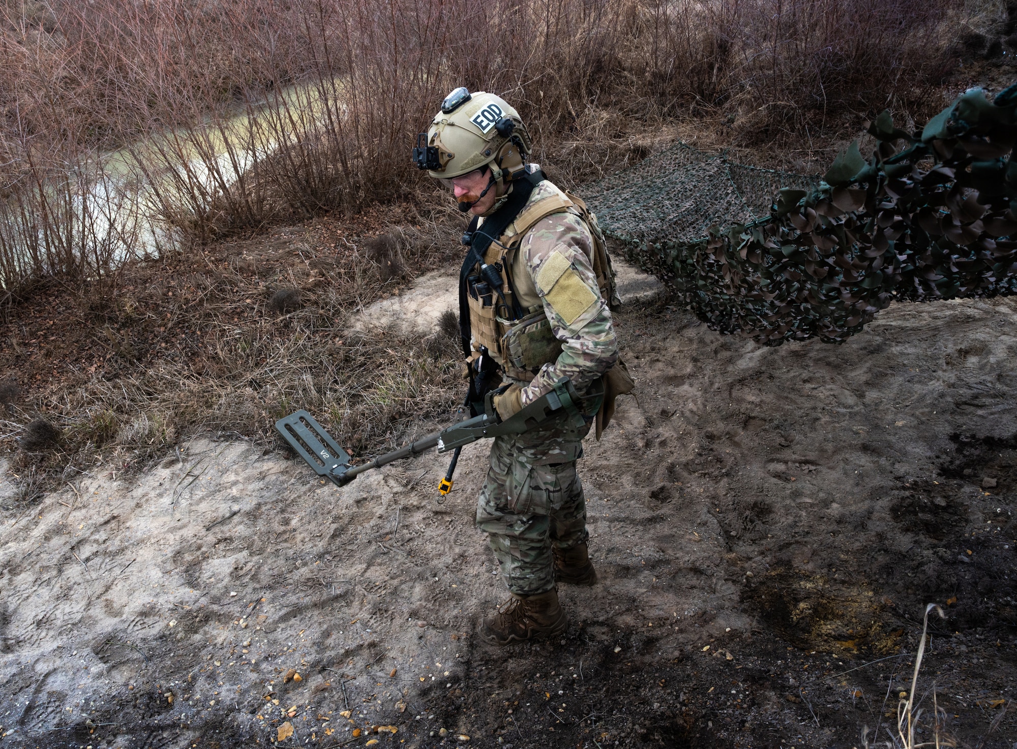 U.S. Air Force Staff Sgt. Appel Aaron, 4th Civil Engineer Squadron, explosive ordnance disposal technician, inspects the area for enemy equipment during a Field Training Exercise at Seymour Johnson Air Force Base, North Carolina, Jan. 21, 2026. The exercise assessed EOD’s ability to rapidly respond to crisis scenarios and evaluated unit proficiency in executing mission-essential tasks while strengthening resilience and adaptability. (U.S. Air Force photo by Airman First Class Holly Leonard)
