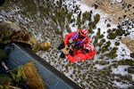 Members from the Big Horn County Search and Rescue Team are raised toward a UH-60 Black Hawk helicopter as a Wyoming Army National Guard crew member looks down during hoist training in the Greybull Mountains in Wyoming, Jan. 28, 2026. The joint exercise improves coordination between aviation crews and ground-based responders during high-angle rescues. Photo by Staff Sgt. Leanna Russell.