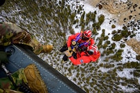 Members from the Big Horn County Search and Rescue Team are raised toward a UH-60 Black Hawk helicopter as a Wyoming Army National Guard crew member looks down during hoist training in the Greybull Mountains in Wyoming, Jan. 28, 2026.
