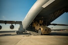 U.S. Airmen load an Army Mine Resistant Ambush Protected vehicle onto a C-17 Globemaster III aircraft in the U.S. Central Command area of responsibility, Jan. 08, 2026. This MRAP was deployed to protect personnel against roadside bombs, mines, and ambush threats in the CENTCOM AOR. (U.S. Air Force photo by Tech. Sgt. Nicholas Monteleone)