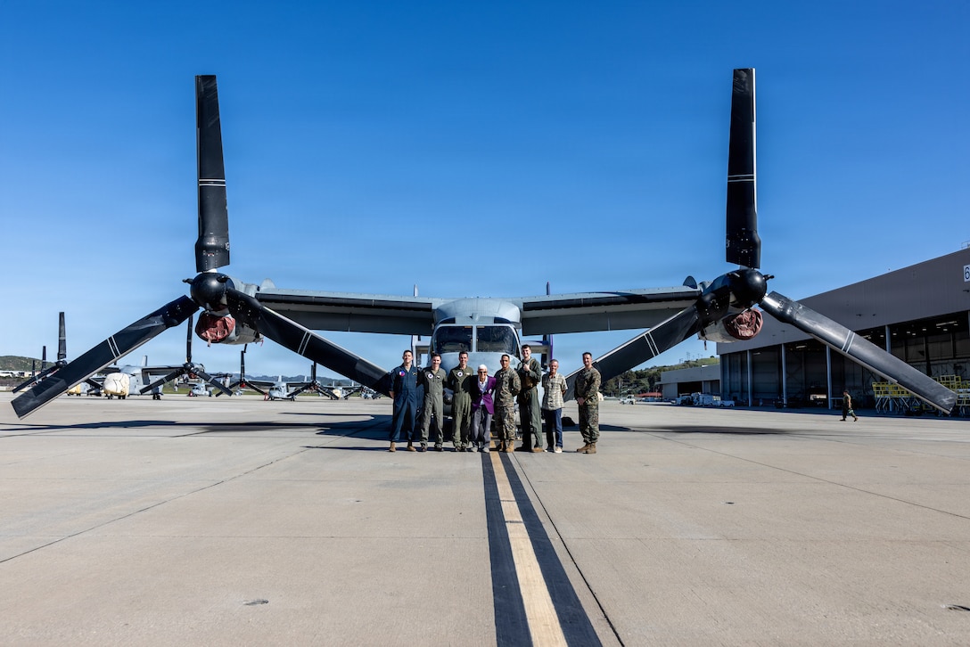 U.S. Marines with Marine Medium Tiltrotor Squadron (VMM) 364, Marine Aircraft Group 39, 3rd Marine Aircraft Wing, and U.S. Marine Corps veteran, Capt. Nelson J. Baker, pose for a group photo in front of an MV-22B Osprey at Marine Corps Air Station Camp Pendleton, California, Jan. 30, 2026. Baker is a plank holder of VMM-364 and served as one of the squadron’s first pilots when it was commissioned as Marine Medium Helicopter Squadron (HMM) 364 in 1961. He visited to share the squadron’s legacy with the current generation of Marines who work with and fly the MV-22B Osprey. (U.S. Marine Corps photo by Lance Cpl. Jonathan Sherchand)
