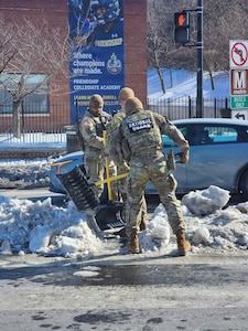Oklahoma National Guardsmen deployed in support of the D.C. Safe and Beautiful mission as part of Task Force Thunder clear snow and ice from walkways around Washington, D.C., after Winter Storm Fern.