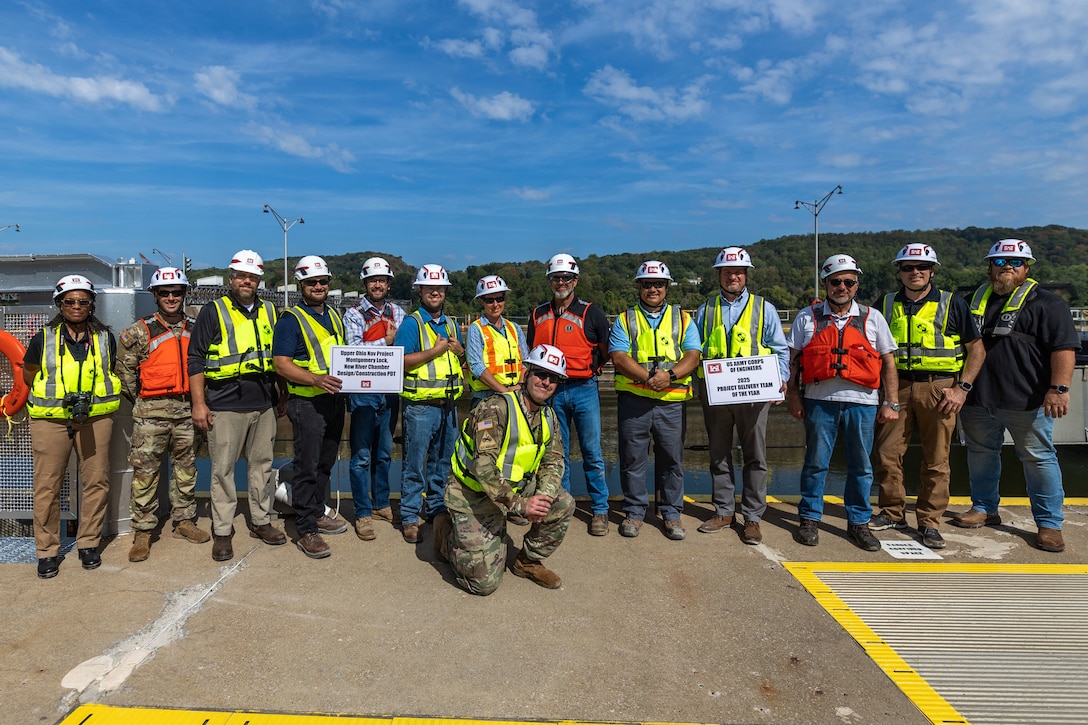 A group of people in construction gear pose for a photo.