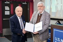 Dr. Gerald Borsuk (left), former U.S. Naval Research Laboratory (NRL) assistant director of research, receives a certificate from NRL Director of Research Dr. Bruce Danly, SES, recognizing his 42 years of service in Washington, D.C., Feb. 5, 2026. Borsuk retired from NRL after completing over four decades of federal service and advancing the Navy’s science and technology program. (U.S. Navy photo by Sarah Peterson)