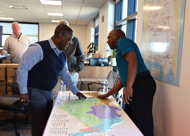 Two men pointing at a map