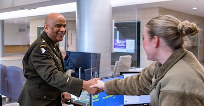 FORT BELVOIR, Va. (February 8, 2026)--Chaplain (Maj.) Scott Norman greets a staff member while making rounds at the A.T. Augusta Military Medical Center (ATAMMC) February 6, 2026.