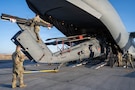 U.S. Airmen unload an HH-60W helicopter from a C-17 Globemaster III at a base in the U.S. Central Command area of responsibility, Jan. 31, 2026. Designed for long-range, high-threat environments, the HH-60W expands combat rescue capability with increased range, survivability, and mission flexibility. (U.S. Air Force photo by Senior Airman Kari Degraffenreed)