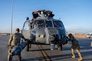 U.S. Airmen push an HH-60W helicopter down the flight line after unloading it from a C-17 Globemaster III at a base in the U.S. Central Command area of responsibility, Jan. 31, 2026. Designed for long-range, high-threat environments, the HH-60W expands combat rescue capability with increased range, survivability, and mission flexibility. (U.S. Air Force photo by Senior Airman Kari Degraffenreed)