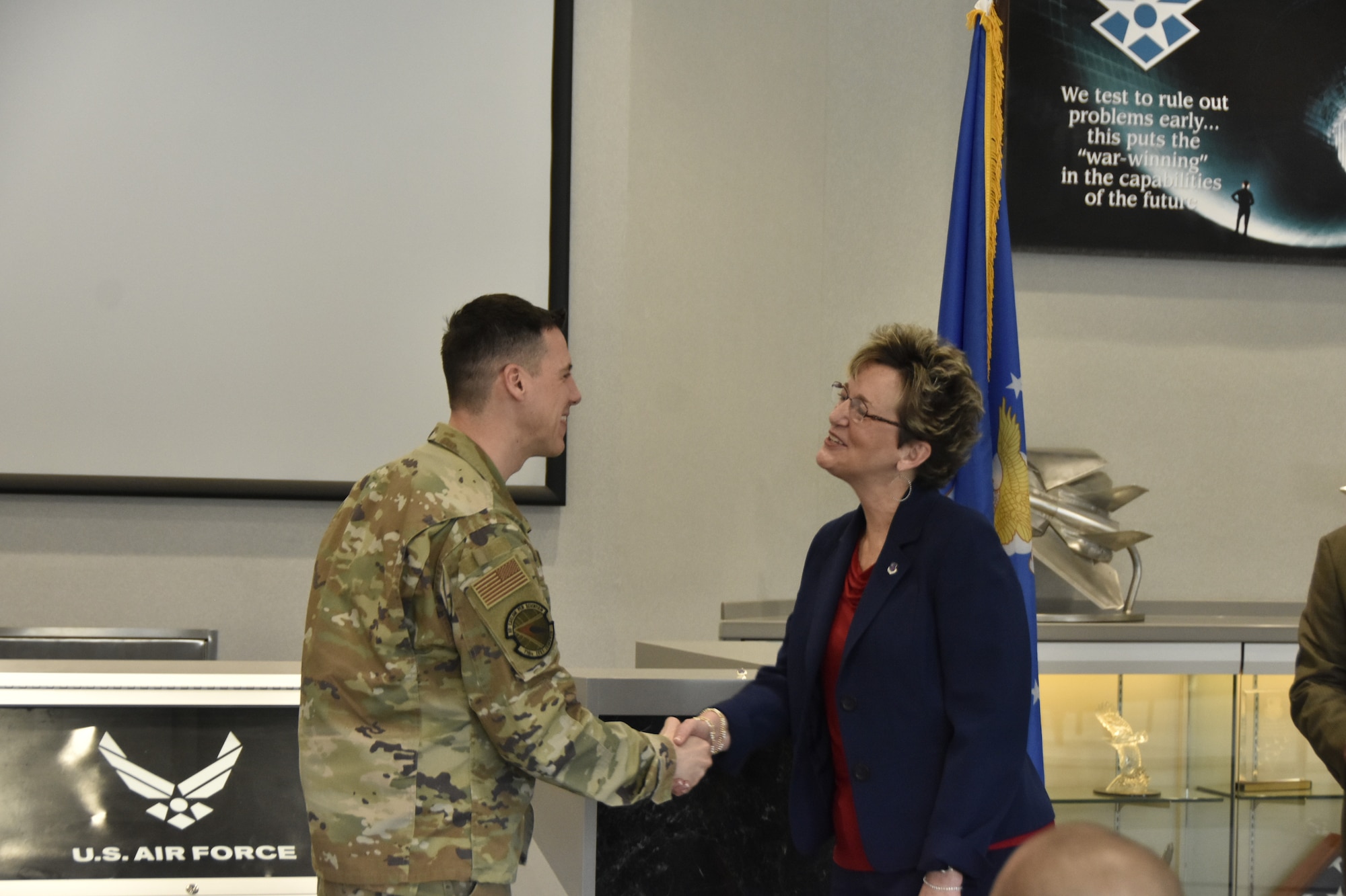 Catherine Stephens, Ph.D., superintendent of Tullahoma City Schools, right, shakes hands with then-716th Test Squadron Commander Lt. Col. James Gresham after receiving her Honorary Commander lapel pin during the March 8, 2024, ceremony at Arnold Air Force Base, Tenn., to induct the first class of Arnold AFB Honorary Commanders. Arnold AFB is the headquarters of AEDC. (U.S. Air Force photo by Brad Hicks)