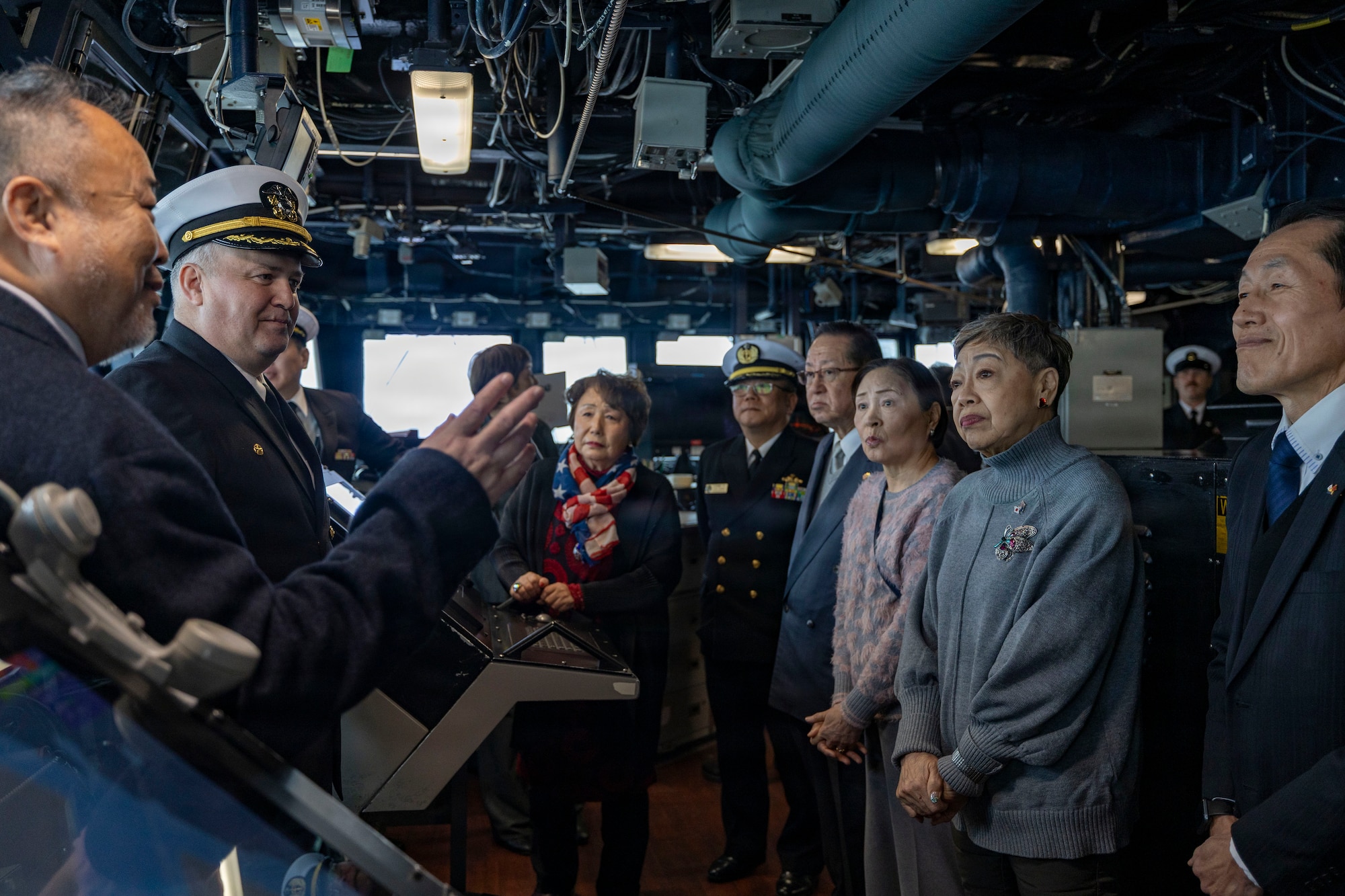 U.S. Navy Cmdr. Ivan Dobrev, commanding officer of Arleigh Burke-class guided-missile destroyer USS Dewey (DDG 105), center left, hosts a tour of the ship’s bridge for members of Otaru Self-Defense Forces Supporters Association (SDFSA), during a port visit to Otaru, Japan, Feb. 6, 2026. Dewey is forward-deployed and assigned to Destroyer Squadron (DESRON) 15, the Navy’s largest DESRON and the U.S. 7th Fleet’s principal surface force. U.S. 7th Fleet is the Navy’s largest forward-deployed numbered fleet, and routinely interacts and operates with allies and partners in preserving a free and open Indo-Pacific region. (U.S. Navy photo by Mass Communication Specialist 2nd Class Oscar Diaz)