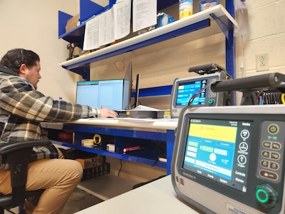 Ramon Pereyra, a biomedical equipment technician for U.S. Army Medical Logistics Command, completes paperwork after finishing a repair of a ventilator device at the Forward Repair Activity-Medical, or FRA-M, site at Fort Bragg, North Carolina.