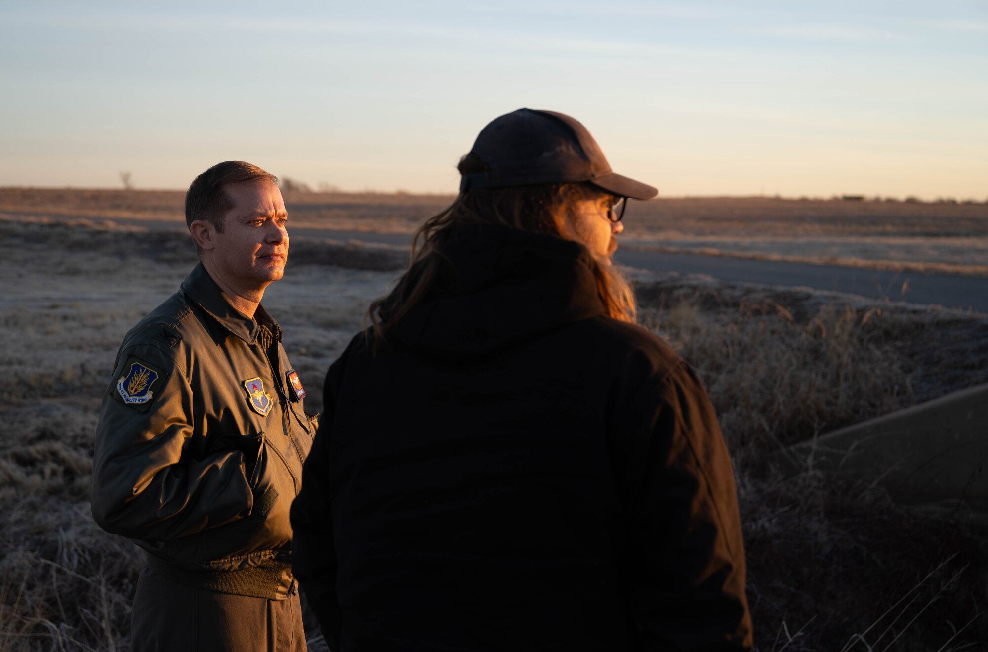 U.S. Air Force Col. Richard Kind, 97th Air Mobility Wing commander, left, talks with Mitchell Singer, U.S. Department of Agriculture (USDA) wildlife biologist, right, at Altus Air Force Base (AFB), Oklahoma, Feb. 5, 2026. Singer discussed the USDA’s execution of the Bird/Wildlife Aircraft Strike Hazard program, the goal of which is to minimize local and transient aircraft exposure to potentially hazardous bird/animal strikes at or near Altus AFB. (U.S. Air Force photo by Airman 1st Class Emma Wright)