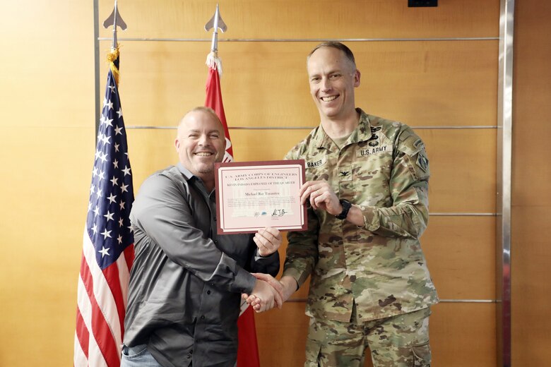 Col. Andrew J Baker, U.S. Army Corps of Engineers Los Angeles District Commander, poses with Michael R. Turanitza, U.S. Army Corps of Engineers Los Angeles District Deputy Chief of Operations Division, as Turanitza receives the Kevin Inada Employee of the Quarter Award Feb. 5 in the downtown Los Angeles District headquarters building on Wilshire Drive.