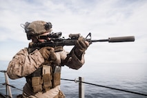 U.S. Marine Corps Sgt. Henry Teter, a machine gunner with Lima Company, Battalion Landing Team 3/5, 11th Marine Expeditionary Unit, sights in on an M4 carbine aboard San Antonio-class amphibious transport dock ship USS Portland (LPD 27) during a simulated strait transit in the Pacific Ocean, Jan. 27, 2026. The simulated strait transit was conducted to refine the 11th MEU’s ability to integrate with the Navy for enhanced force protection.  The 11th MEU is currently underway aboard the Boxer Amphibious Ready Group in the U.S. 3rd Fleet area of operations conducting integrated training that enhances lethality and warfighting readiness. (U.S. Marine Corps photo by Lance Cpl. Luke Rodriguez)