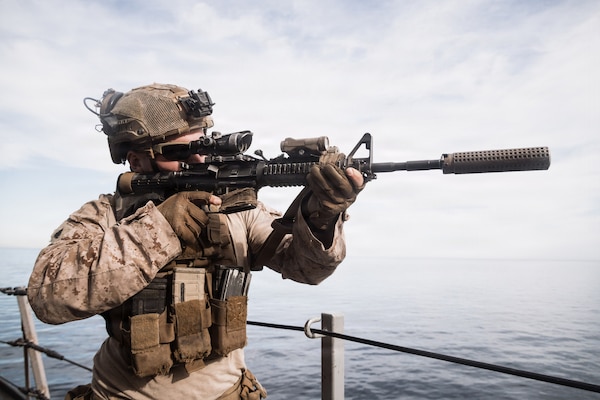 U.S. Marine Corps Sgt. Henry Teter, a machine gunner with Lima Company, Battalion Landing Team 3/5, 11th Marine Expeditionary Unit, sights in on an M4 carbine aboard San Antonio-class amphibious transport dock ship USS Portland (LPD 27) during a simulated strait transit in the Pacific Ocean, Jan. 27, 2026. The simulated strait transit was conducted to refine the 11th MEU’s ability to integrate with the Navy for enhanced force protection.  The 11th MEU is currently underway aboard the Boxer Amphibious Ready Group in the U.S. 3rd Fleet area of operations conducting integrated training that enhances lethality and warfighting readiness. (U.S. Marine Corps photo by Lance Cpl. Luke Rodriguez)