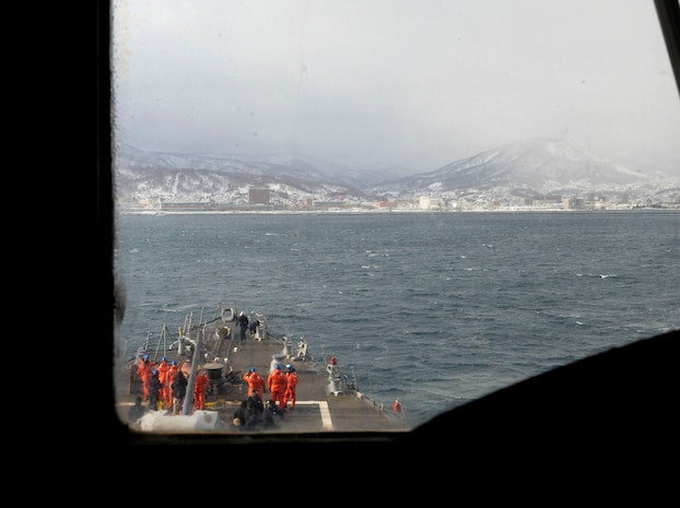 U.S. Navy Sailors take positions on the fo’c’sle as part of a sea and anchor detail aboard Arleigh Burke-class guided-missile destroyer USS Dewey (DDG 105) while conducting a port visit to Otaru, Japan, Feb. 6, 2026. Dewey is forward-deployed and assigned to Destroyer Squadron (DESRON) 15, the Navy’s largest DESRON and the U.S. 7th Fleet’s principal surface force. U.S. 7th Fleet is the Navy’s largest forward-deployed numbered fleet, and routinely interacts and operates with allies and partners in preserving a free and open Indo-Pacific region. (U.S. Navy photo by Mass Communication Specialist 2nd Class Oscar Diaz)