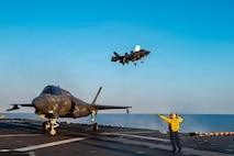 Aviation Boatswain’s Mate (Aircraft Handling) 1st Class Jaime Martinez directs the landing of multiple F-35B Lighting IIs, attached to Marine Fighter Attack Squadron (VMFA) 121, during flight operations aboard America-class amphibious assault ship USS Tripoli (LHA 7), Feb. 5, 2026.