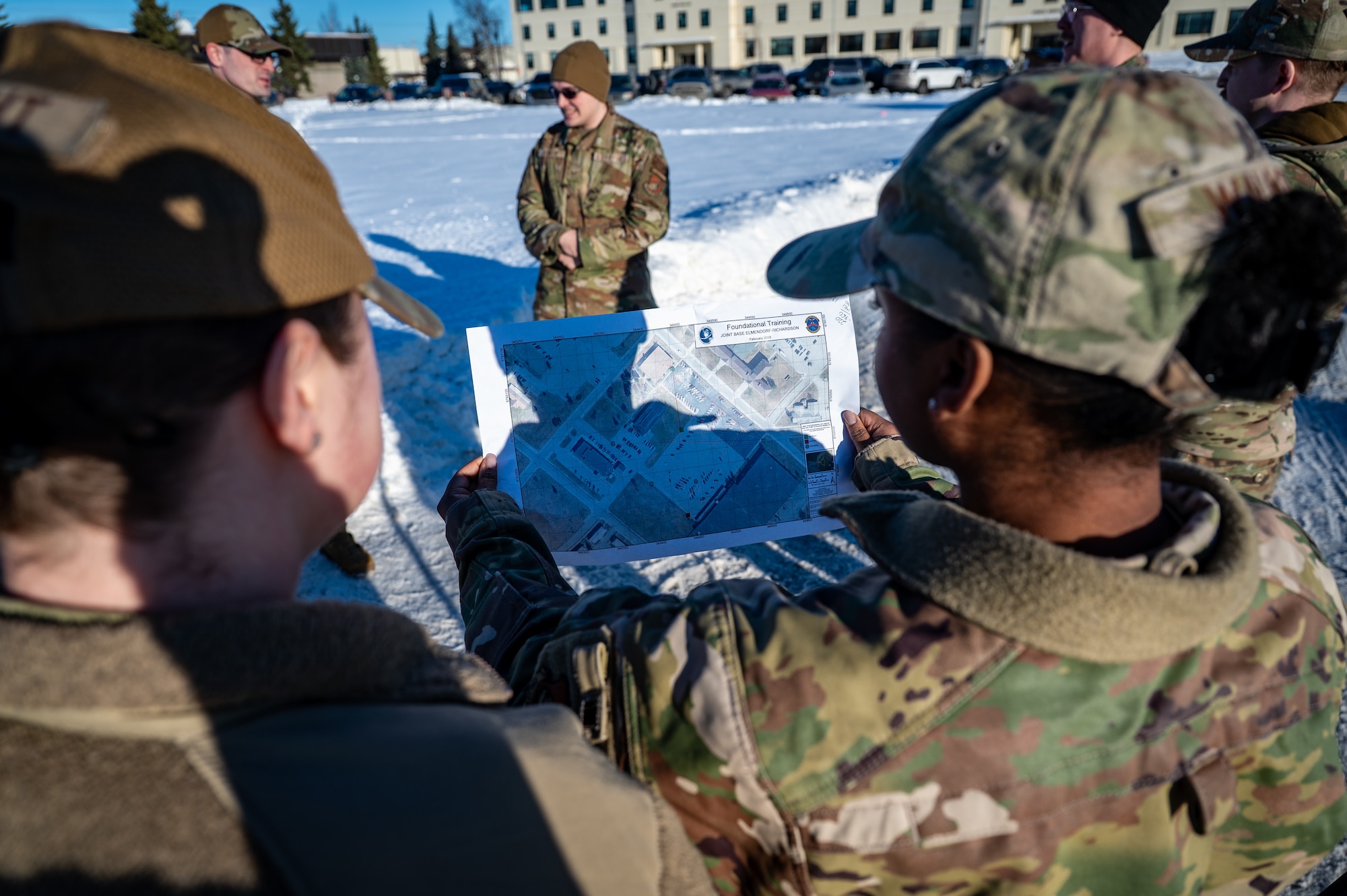 U.S. Air Force Tech. Sgt. Alexis Walker, 611th Civil Engineer Squadron operations manager, uses a map during the land navigation training of the Mission Ready Airman training portion of the Professional Development Center’s Noncommissioned Officer Foundation Course 500 at Joint Base Elmendorf-Richardson, Alaska, Feb. 6, 2026. Land navigation exercises prepare Airmen to maintain mission effectiveness when GPS or communications are limited. (U.S. Air Force photo by Senior Airman Hunter Hites)
