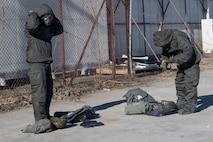 People don their personal protective chemical equipment.
