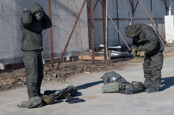 People don their personal protective chemical equipment.