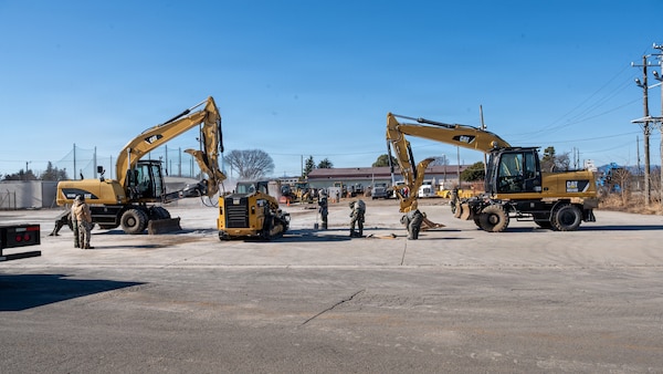 Construction equipment operates on concrete.
