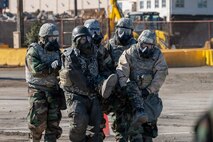 U.S. Air Force and Japan Air Self-Defense Force Airmen carry a simulated casualty.