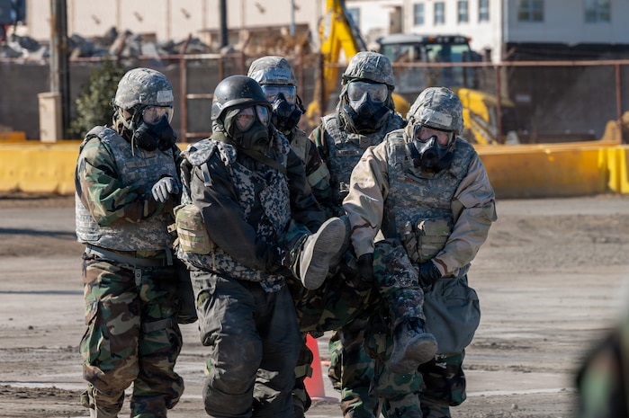 U.S. Air Force and Japan Air Self-Defense Force Airmen carry a simulated casualty.