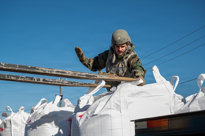 An Airman signals a forklift.