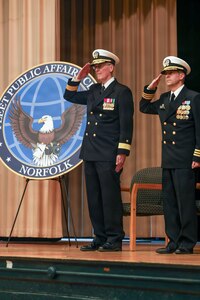 NORFOLK, Va. (Jan. 9, 2026) – Rear Adm. John A. Robinson, Navy Chief of Information, left, and Cmdr. Jason S. Fischer, commanding officer of Fleet Public Affairs Center (FLTPACEN) Norfolk, salute the ensign during the national anthem during an establishment ceremony at Naval Station Norfolk, Jan. 9, 2026. The establishment ceremony coincided with the inauguration of Navy Public Affairs Command, formerly Navy Public Affairs Support Element, and is part of a Navy-wide public affairs transformation designed to better align communication efforts with the fleet and to create a more agile and efficient communication force. (U.S. Navy photo by Mass Communication Specialist 2nd Class Troy Davis)