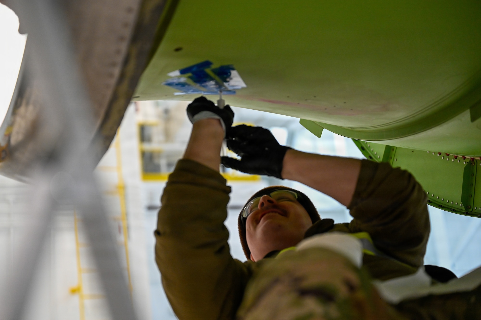 Mechanic works on aircraft