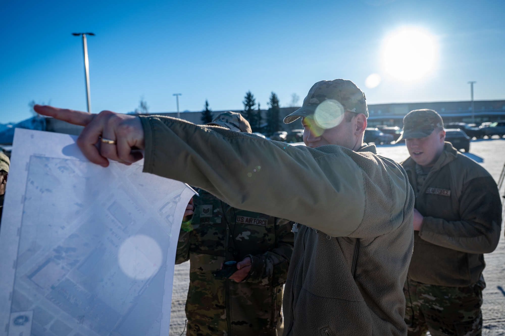 U.S. Air Force Tech. Sgt. Conner Cech, 3rd Munitions Squadron operations supervisor, uses a compass and map during the land navigation training of the Mission Ready Airman training portion of the Professional Development Center’s Noncommissioned Officer Foundation Course 500 at Joint Base Elmendorf-Richardson, Alaska, Feb. 6, 2026. Students practice terrain association and map-reading skills essential for operating without digital aids in contested environments. (U.S. Air Force photo by Senior Airman Hunter Hites)