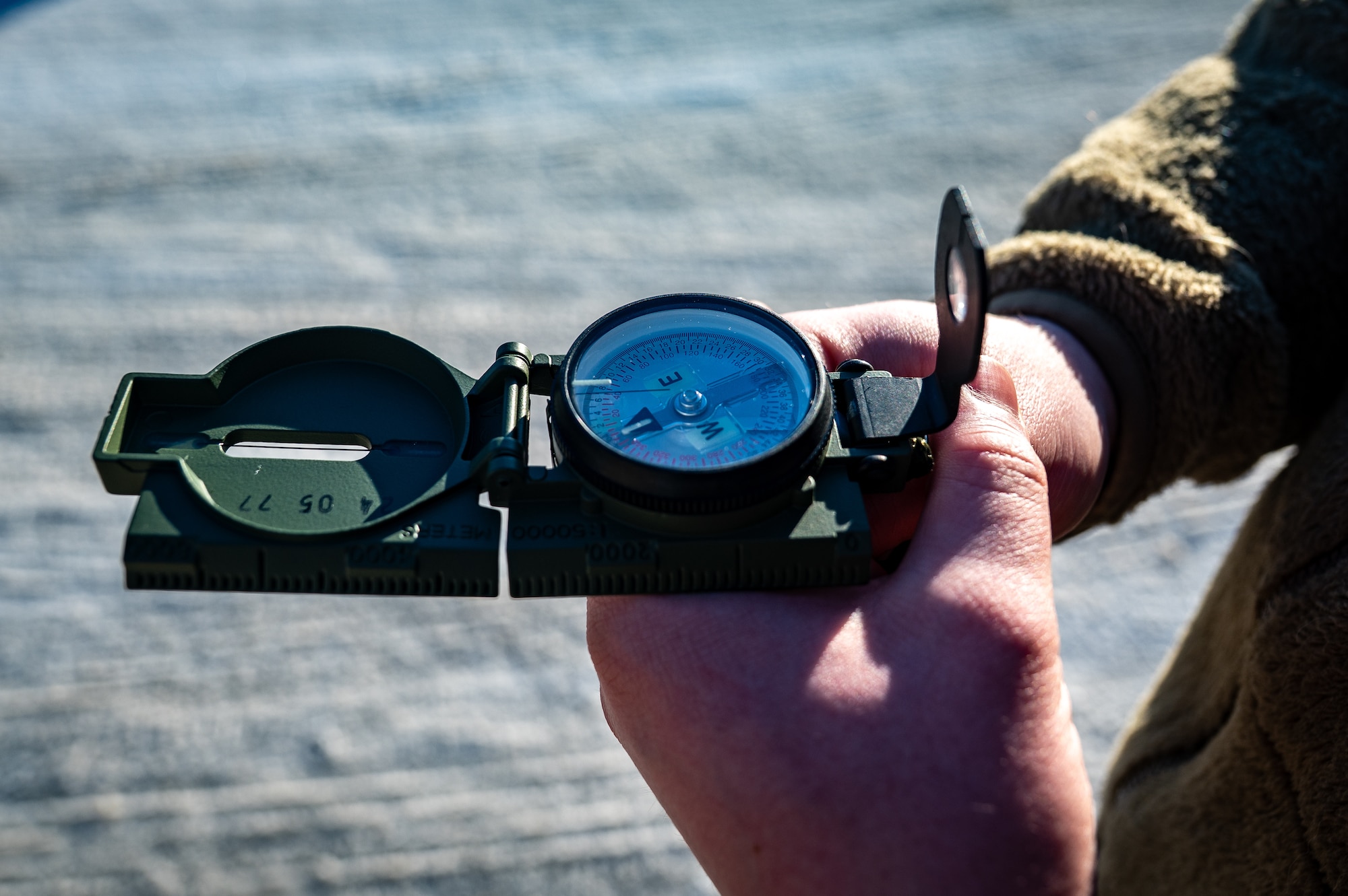 A Joint Base Elmendorf-Richardson Airman uses a compass during the land navigation course in the Mission Ready Airman training portion of the Professional Development Center’s Noncommissioned Officer Foundation Course 500 at JBER, Alaska, Feb. 6, 2026. Land navigation training strengthens students’ ability to operate independently and orient themselves in unfamiliar environments. (U.S. Air Force photo by Senior Airman Hunter Hites)