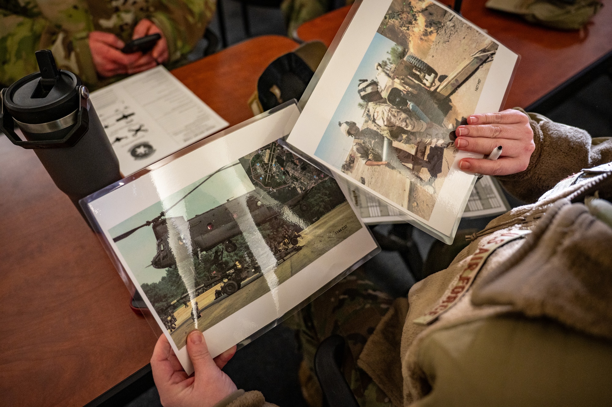 A Joint Base Elmendorf-Richardson Airman assesses photos in order to give a Size, Activity, Location, Unit, Time, Equipment report during the land mobile radio training of the Mission Ready Airman training portion of the Professional Development Center’s Noncommissioned Officer Foundation Course 500 at JBER, Alaska, Feb. 6, 2026. The training reinforces clear, disciplined communication to support command and control during operations. (U.S. Air Force photo by Senior Airman Hunter Hites)