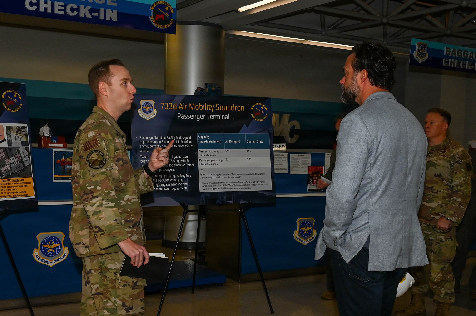 Service member briefs government official.