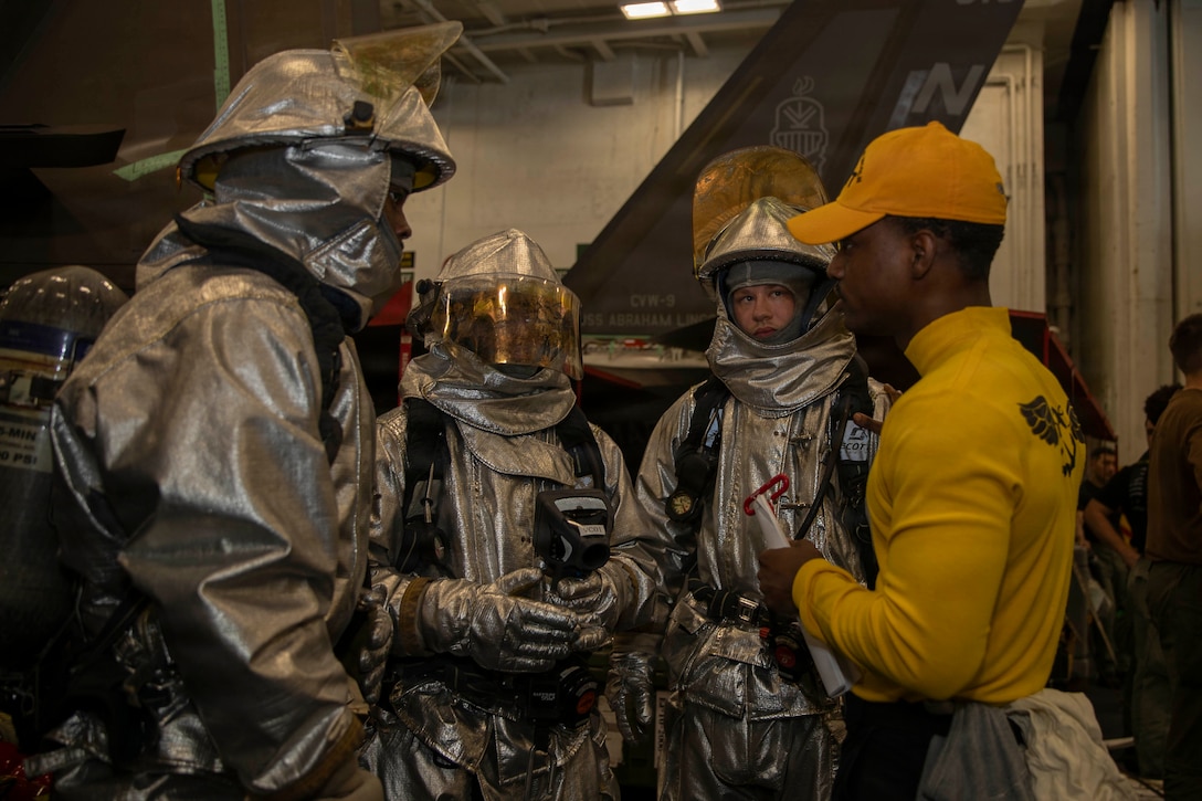 U.S. Sailors participate in a mass casualty drill in the hangar bay of Nimitz-class aircraft carrier USS Abraham Lincoln (CVN 72) in the Arabian Sea, Feb. 5, 2026. Abraham Lincoln is deployed to the U.S. 5th Fleet area of operations to support maritime security and stability in the U.S. Central Command area of responsibility. (U.S. Navy photo by Mass Communication Specialist Seaman Apprentice Cesar Zavala)