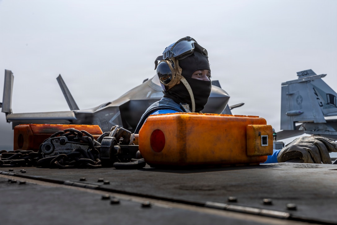 U.S. Navy Aviation Boatswain’s Mate (Handling) Airman Tomfei Adiim observes flight operations on the flight deck of Nimitz-class aircraft carrier USS Abraham Lincoln (CVN 72) in Arabian Sea, Feb. 5, 2026. Abraham Lincoln is deployed to the U.S. 5th Fleet area of operations to support maritime security and stability in the U.S. Central Command area of responsibility. (U.S. Navy photo by Mass Communication Specialist Seaman Daniel Kimmelman)