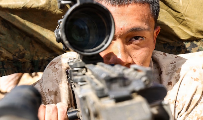 A U.S. Marine assigned to Fleet Anti-Terrorism Security Team Central Command, sights in on an M240B machine gun during exercise Indigo Defender 26 at King Faisal Naval Base, Saudi Arabia, Feb. 4, 2026. Indigo Defender 26 is a capstone bilateral maritime exercise between Royal Saudi Naval Forces and U.S. Naval Forces Central Command to enhance interoperability and strengthen our capacity to maintain regional maritime security and stability.  (U.S. Marine Corps photo by Sgt. Angela Wilcox)