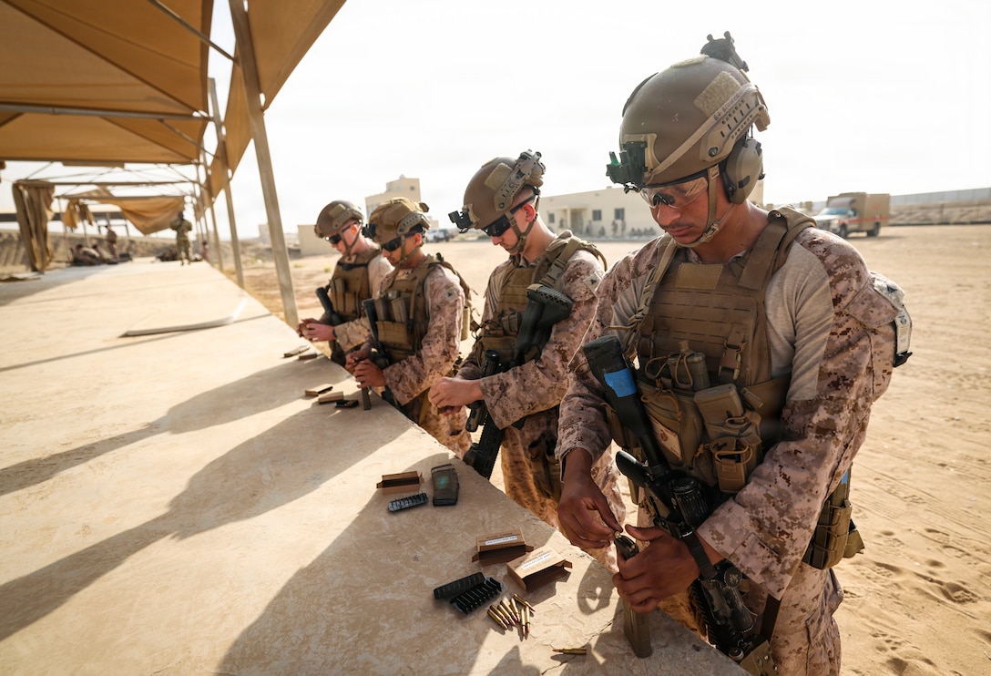 U.S. Marines assigned to Fleet Anti-Terrorism Security Team Central Command, load magazines for a live-fire range during exercise Indigo Defender 26 at King Faisal Naval Base, Saudi Arabia, Feb. 2, 2026. Indigo Defender 26 is a capstone bilateral maritime exercise between Royal Saudi Naval Forces and U.S. Naval Forces Central Command to enhance interoperability and strengthen our capacity to maintain regional maritime security and stability.  (U.S. Marine Corps photo by Sgt. Angela Wilcox)