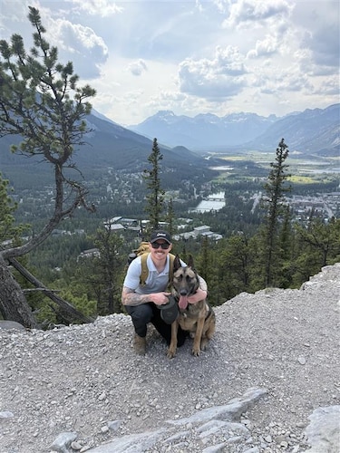 Staff Sgt. Ben Tombs-Webster, 88th Security Forces Squadron military working dog handler, and MWD Flex, 88 SFS patrol explosive detection dog, are pictured June 17, 2025, at a National Park in Banff, Canada.