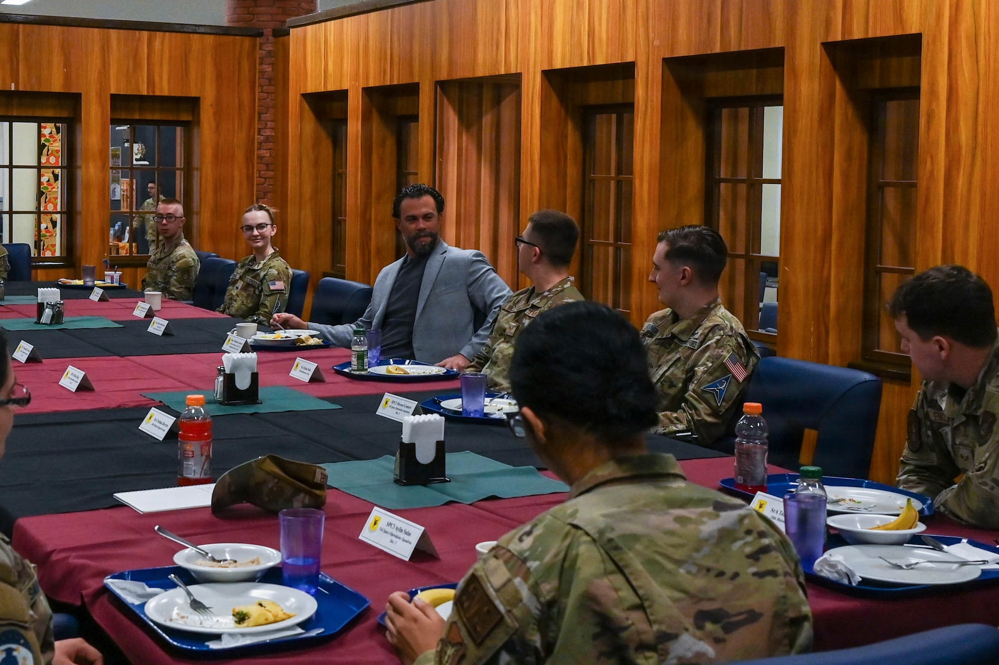 government official engages with service members.