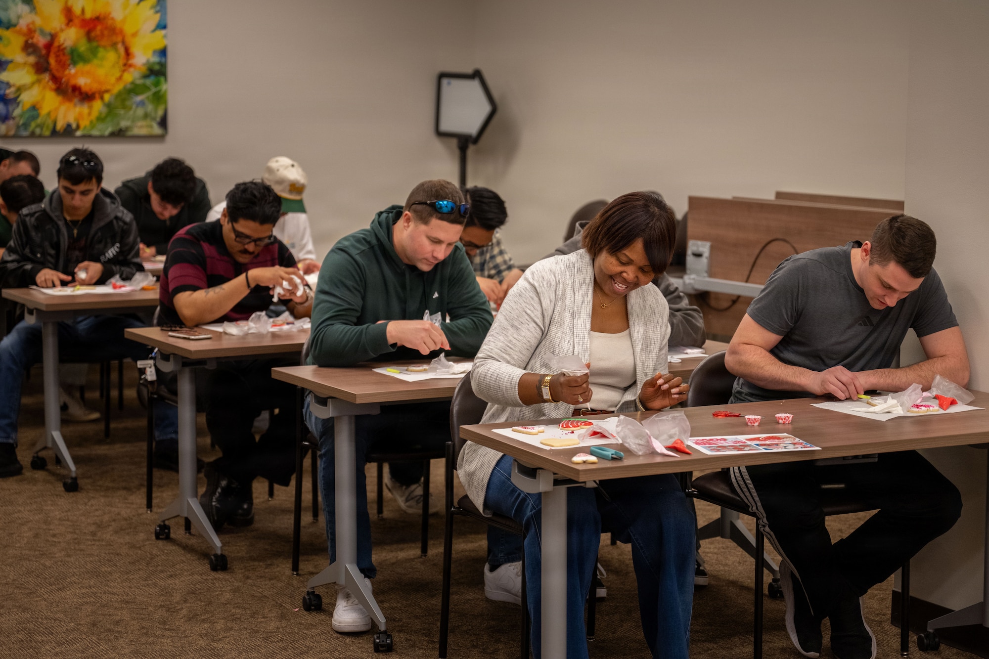 Team McConnell members decorate sugar cookies during a cookie decorating session at Tanker Talks 2.0 on McConnell Air Force Base, Feb. 9, 2026. The class was offered as part of the resiliency focused event, providing attendees an opportunity to engage in a creative activity. (U.S. Air Force photo by Senior Airman Paula Arce)