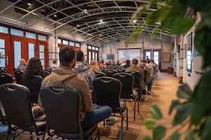 Members of Team McConnell navigate a non-motorized vehicle through a course while wearing impairment simulation goggles during Tanker Talks 2.0 at McConnell Air Force Base, Feb. 9, 2026. The activity was designed to demonstrate how alcohol and THC-related impairment can affect coordination, reaction time and decision-making in a controlled environment. (U.S. Air Force photo by Senior Airman Paula Arce)