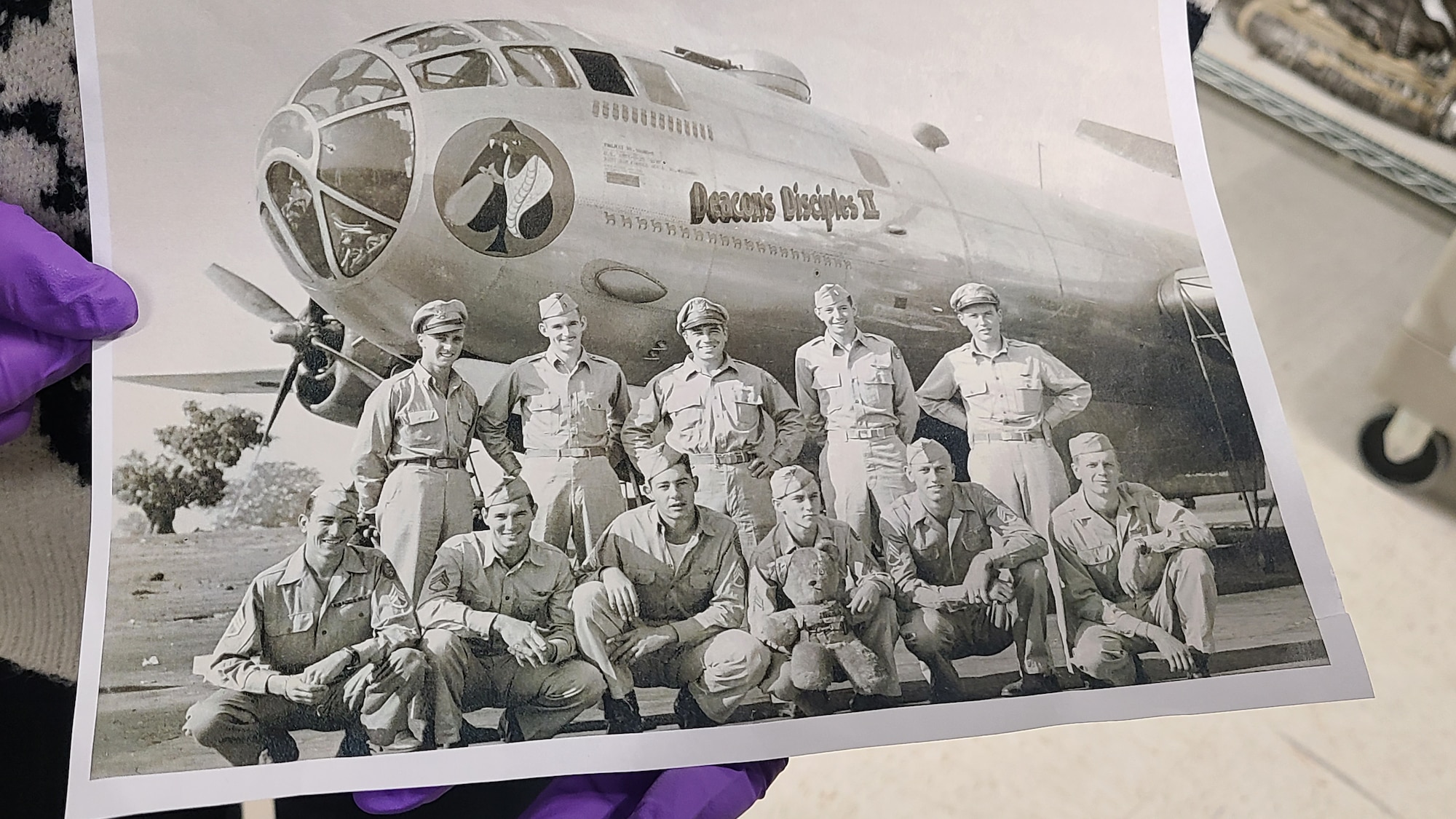 A close-up view shows an original World War II–era photograph of the “Deacon’s Disciples” aircrew posed in front of a B-29 Superfortress, which was the aircraft broke the Hawaii-to-Washington non-stop record of 17 hours, 21 minutes, during a behind-the-scenes tour of the National Museum of the U.S. Air Force Jan. 21, 2026, at Wright-Patterson Air Force Base, Ohio.