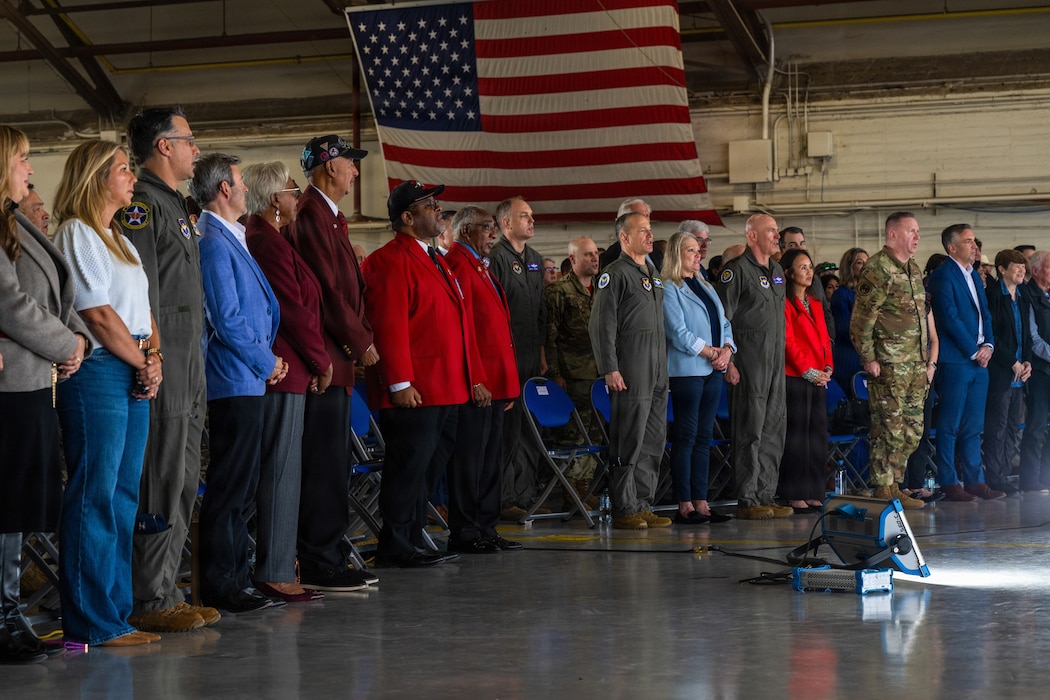 Ceremony attendees stand during the T-7A Red Hawk arrival ceremony