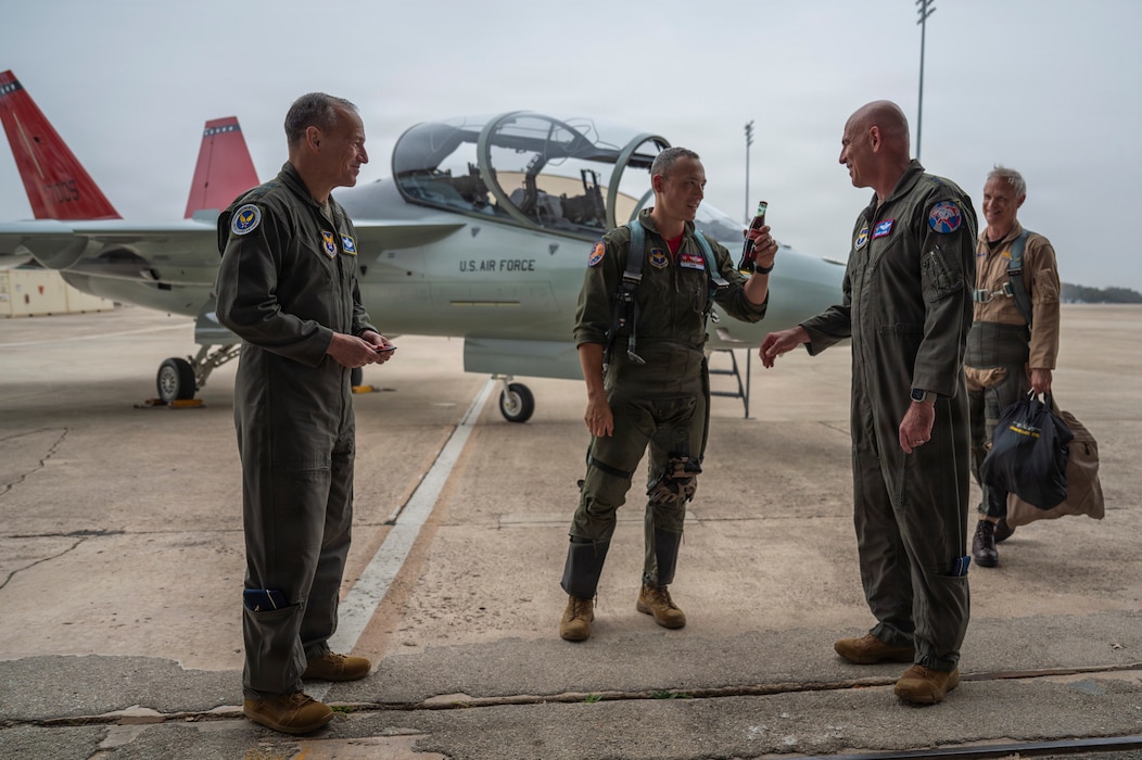 Pilots stand in front of T-7A Red Hawk