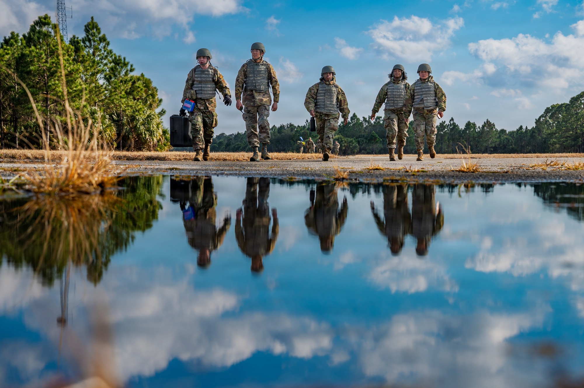 Airman Leadership School students move as a team during a field training exercise at Malabar Training Site, Florida, Feb. 5, 2026. The scenario reinforced Agile Combat Employment concepts by challenging students to operate as a cohesive team outside their primary career fields. (U.S. Space Force photo by Gwen Kurzen)