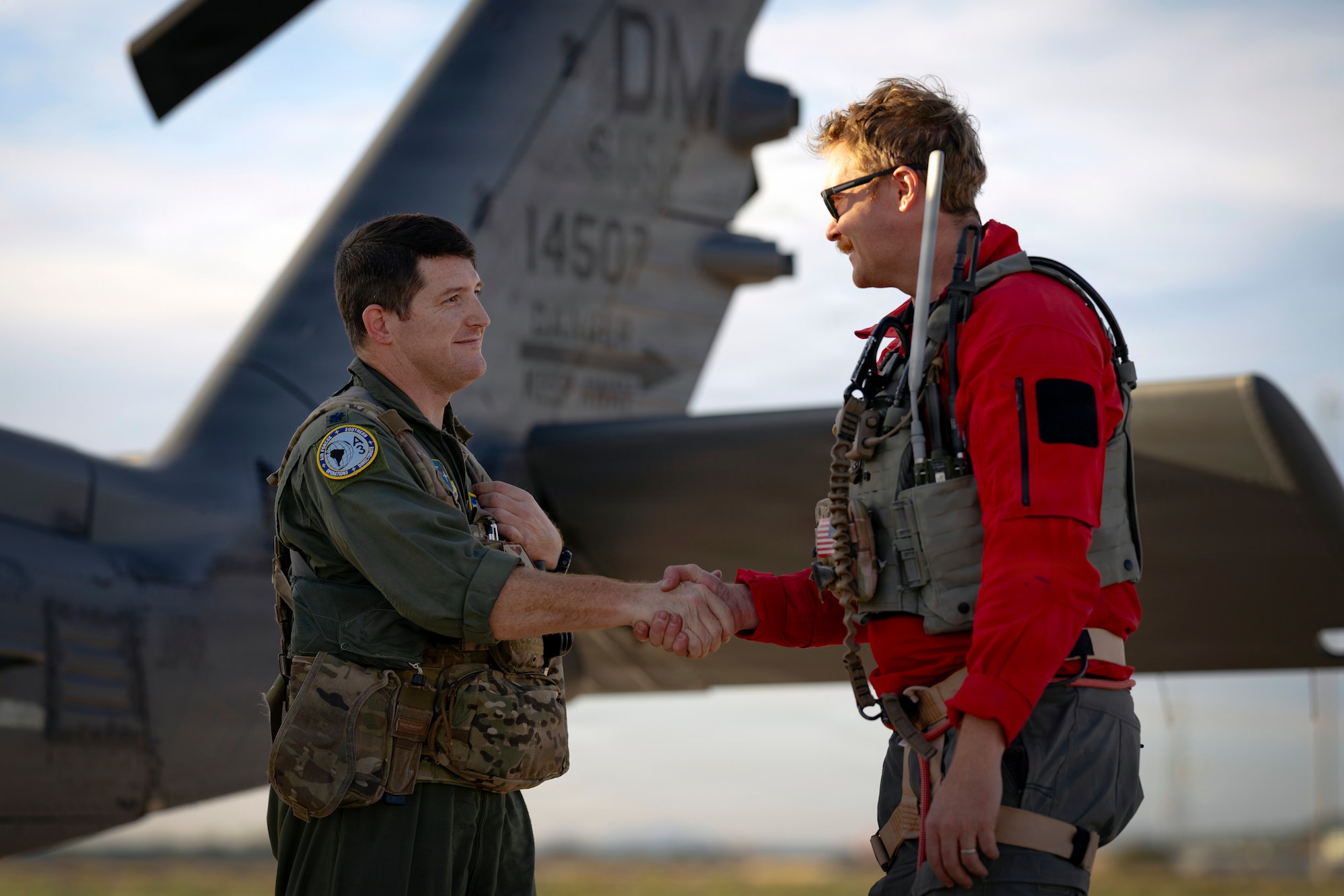 Lt. Col. Jeff Budis, left, Air Forces Southern operations directorate, chief of exercises and airshows shakes hands with Master Sgt. Nicholas Miller, pararescue specialist with the 48th Rescue Squadron at Davis-Monthan Air Force Base, Arizona, after completing a successful rescue mission, Feb. 6, 2026. The mission demonstrated the Air Force rescue community’s ability to rapidly integrate qualified personnel across multiple units to respond when time, distance and personnel availability converge. (U.S. Air Force photo by Tech. Sgt. Rachel Maxwell)