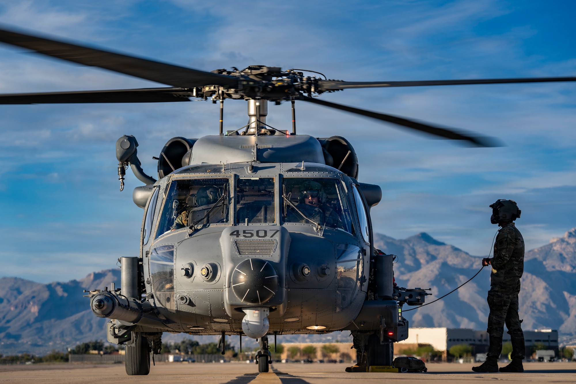 The crew of a U.S. Air Force HH-60W Jolly Green II assigned to the 55th Rescue Squadron conduct post-flight procedures on the flight line at Davis-Monthan Air Force Base, Arizona, Feb. 5, 2026. Rescue Airmen from the 563rd Rescue Group, supported by Air Forces Southern, conducted a long-range water rescue of a civilian aboard a tanker in the Pacific Ocean off the coast of Mexico, (U.S. Air Force photo by Andrea Jenkins)